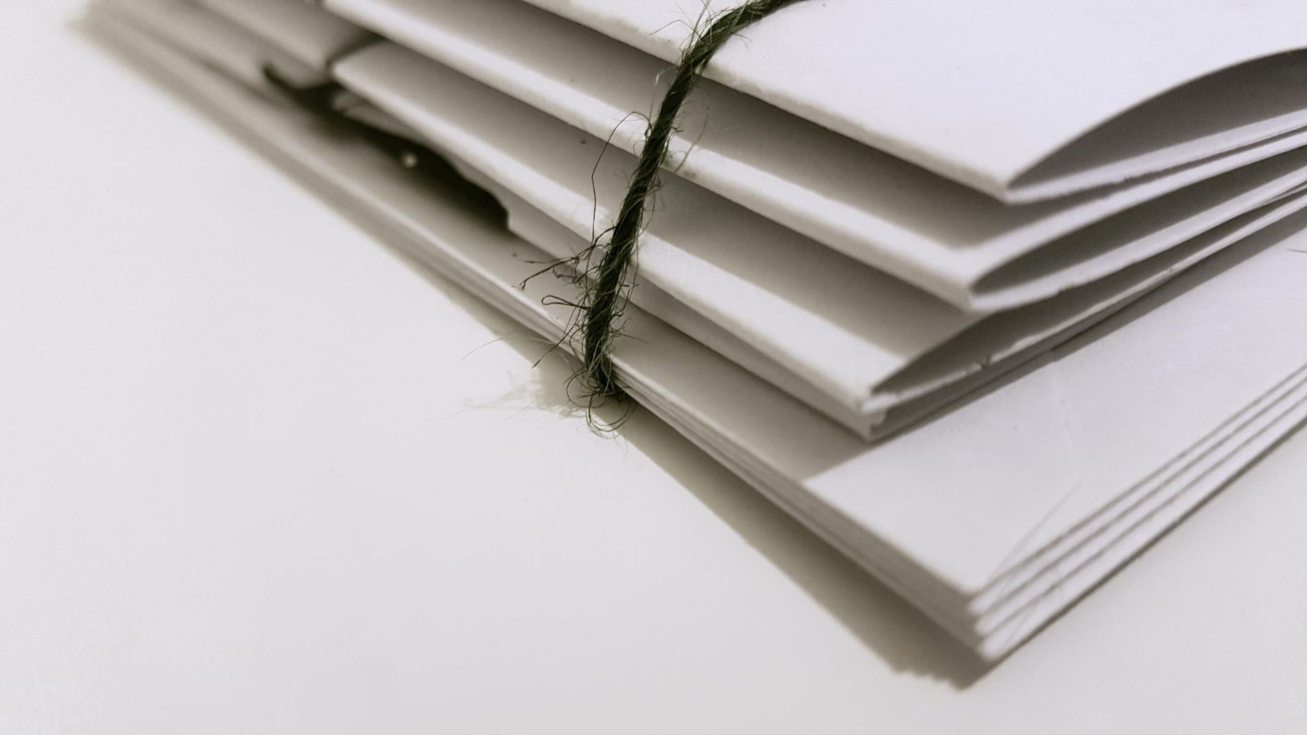 Photo by Sam J on <a href="https://www.pexels.com/photo/white-paper-folders-with-black-tie-1764956/" rel="nofollow">Pexels.com</a>