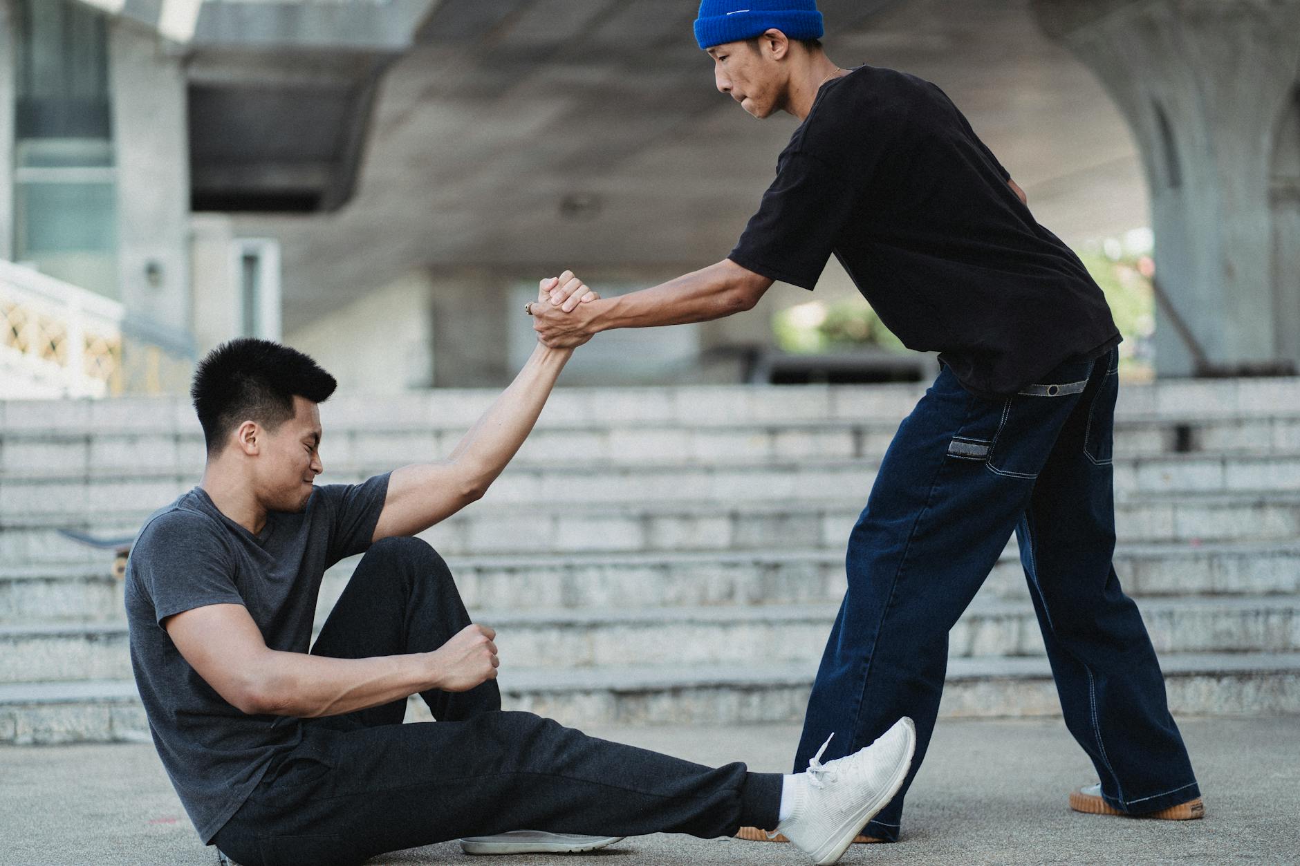 Photo by Allan Mas on <a href="https://www.pexels.com/photo/asian-man-helping-friend-to-get-up-from-ground-5368943/" rel="nofollow">Pexels.com</a>