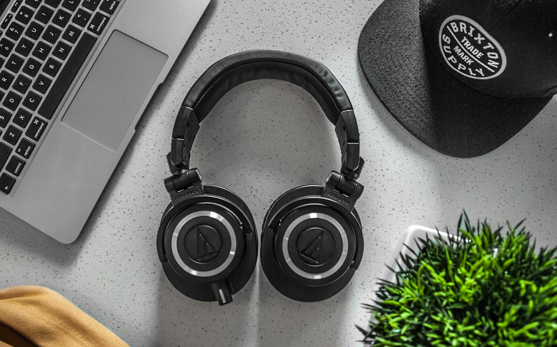 Photo by Garrett Morrow on <a href="https://www.pexels.com/photo/black-wireless-headphones-on-white-table-610945/" rel="nofollow">Pexels.com</a>