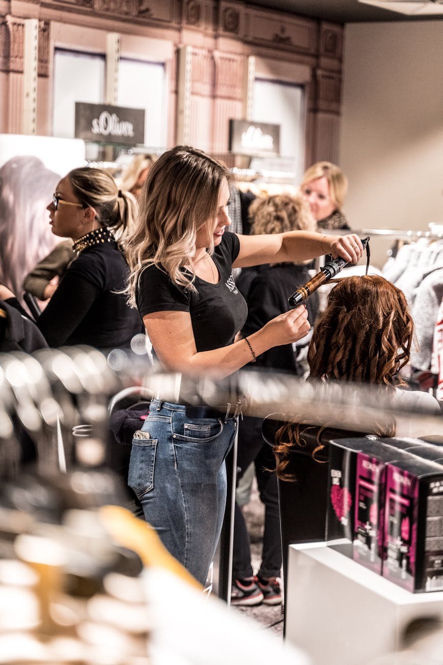 woman curling another woman s hair