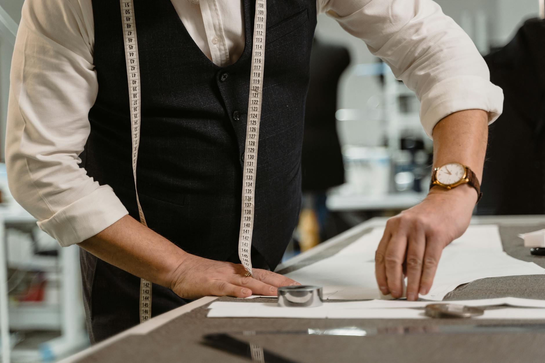 person in white dress shirt and black vest