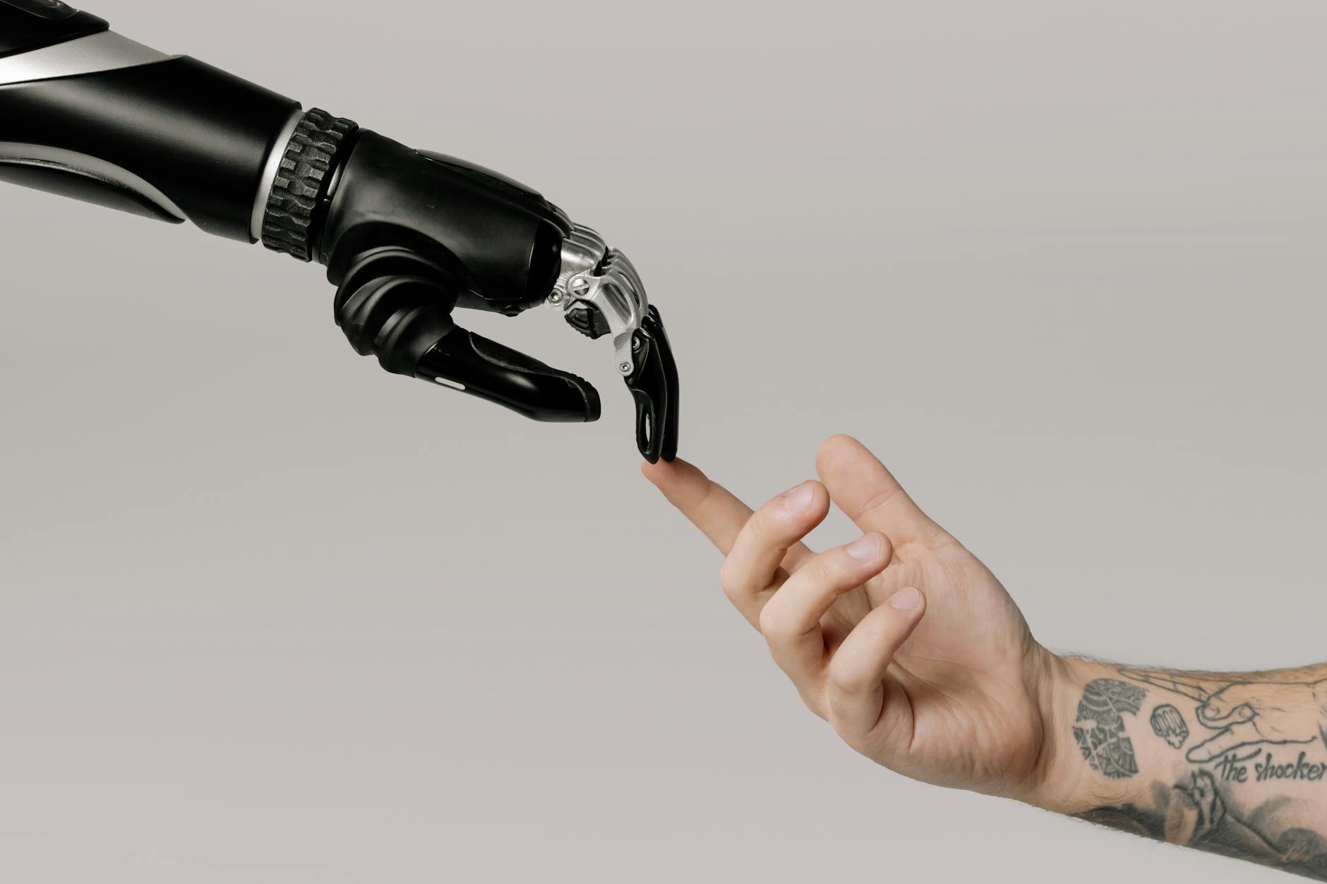 Photo by cottonbro studio on <a href="https://www.pexels.com/photo/bionic-hand-and-human-hand-finger-pointing-6153354/" rel="nofollow">Pexels.com</a>